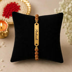 Personalized Name Rudraksha Rakhi – Custom Engraved Gold Finish Metal Bracelet